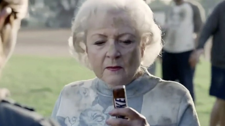 Betty White holding a Snickers bar in a super bowl commercial