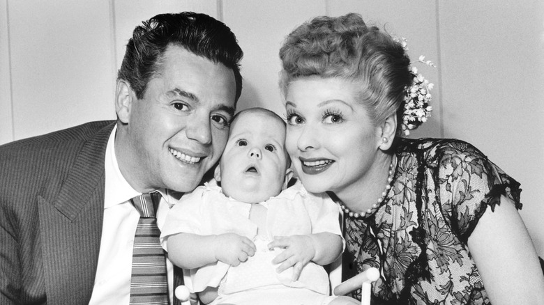 Desi Arnaz and Lucille Ball posing with son Desi Jr.