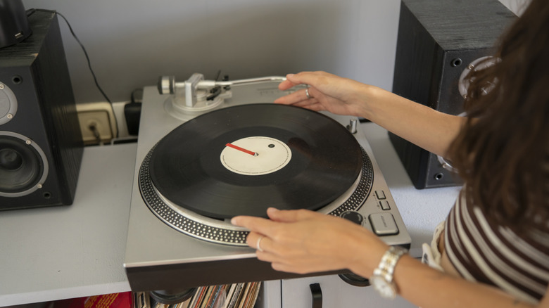 Person putting vinyl on turntable
