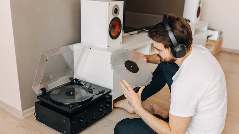Guy placing record on turntable