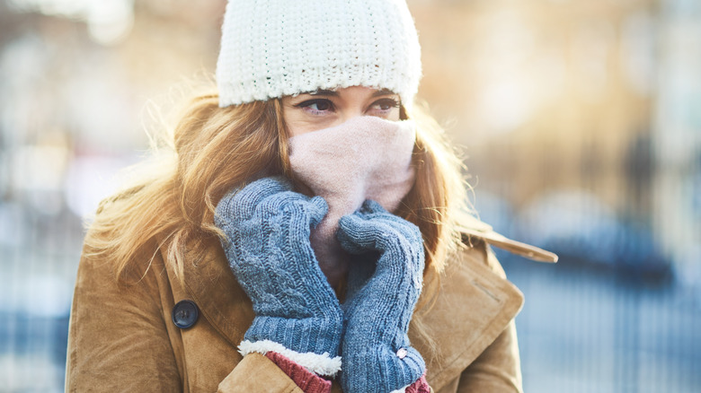 woman with a scarf over her face