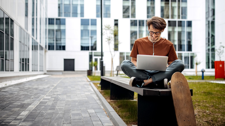 guy using a laptop outside