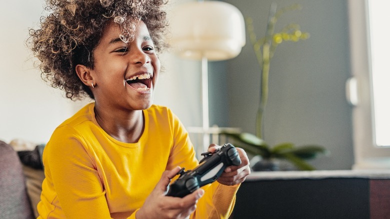 Happy kid playing video games