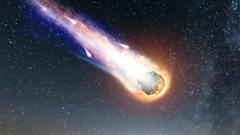 Asteroid falling in flames across night sky
