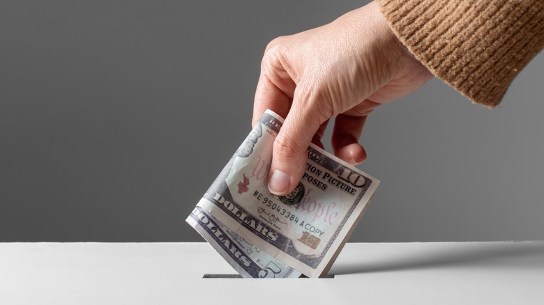 Putting money in the donation box