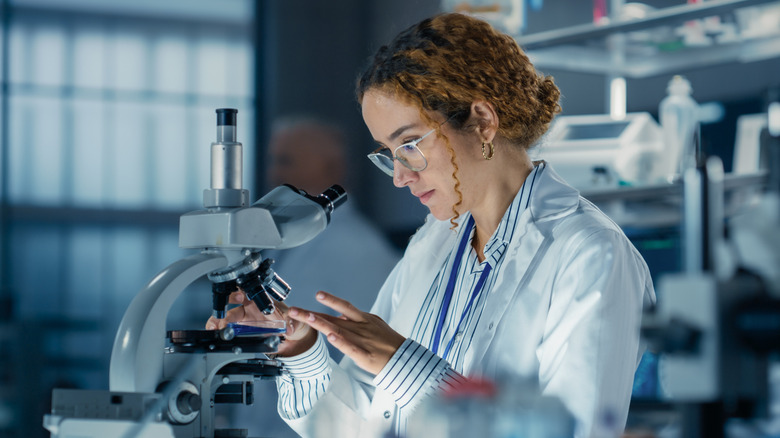 Woman looking at a sample under a microscope