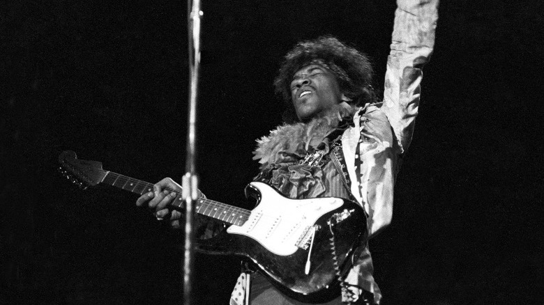 Jimi Hendrix playing guitar onstage