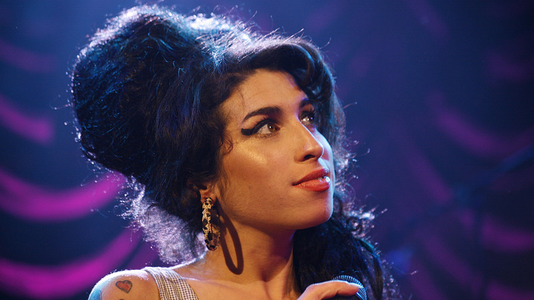 Amy Winehouse smiling on stage