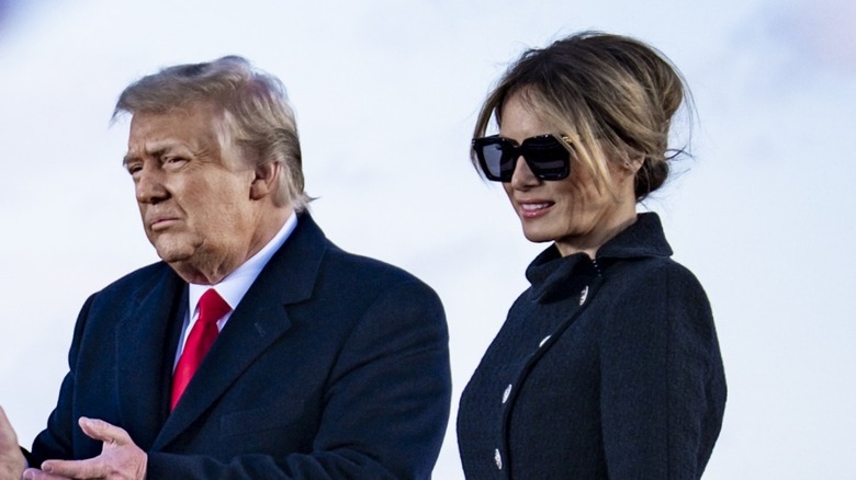 Donald and Melania Trump looking down suits
