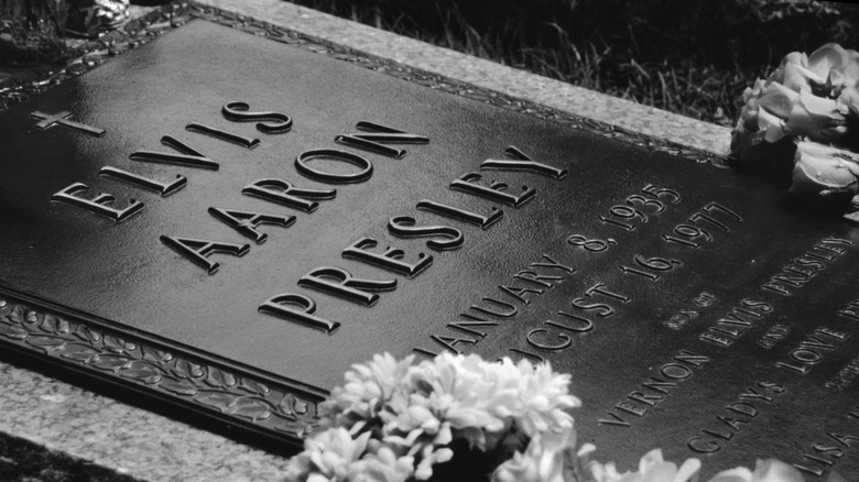 Closeup of Elvis gravestone with full name, black and white.