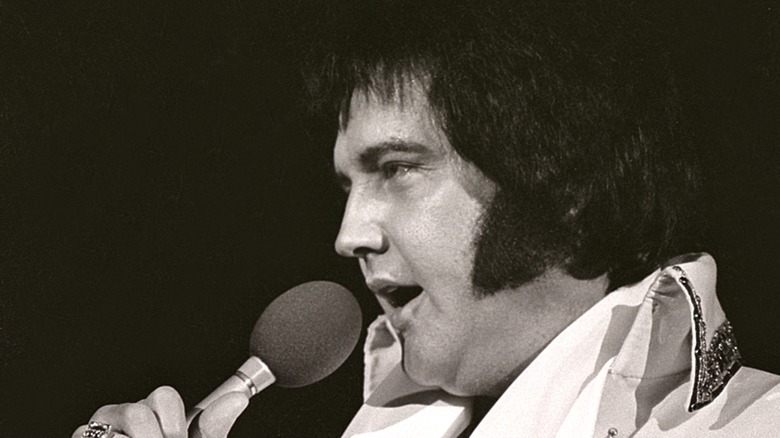 Elvis Presley singing into microphone