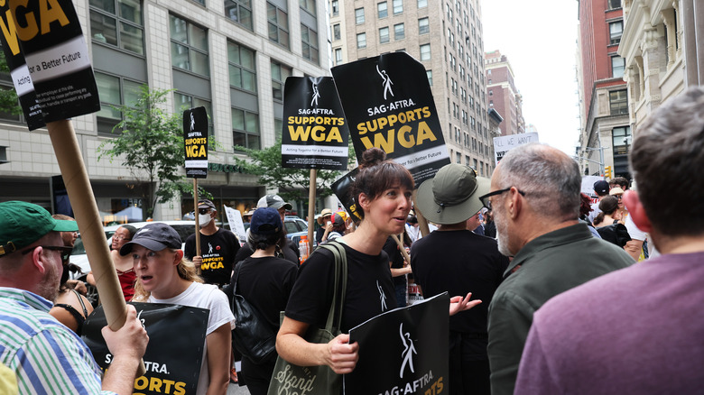 SAG-AFTRA WGA members together with signs