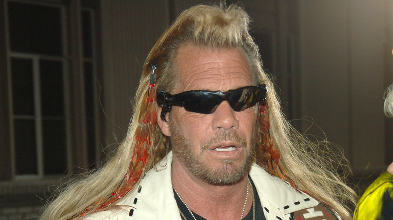 Dog the bounty hunter in shades and white jacket