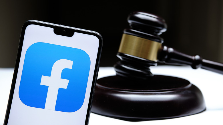Facebook logo on phone with gavel in background