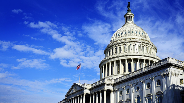 U.S. Capitol blue sky flag fluttering