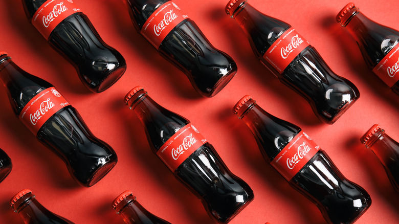 Coca Cola bottles on red