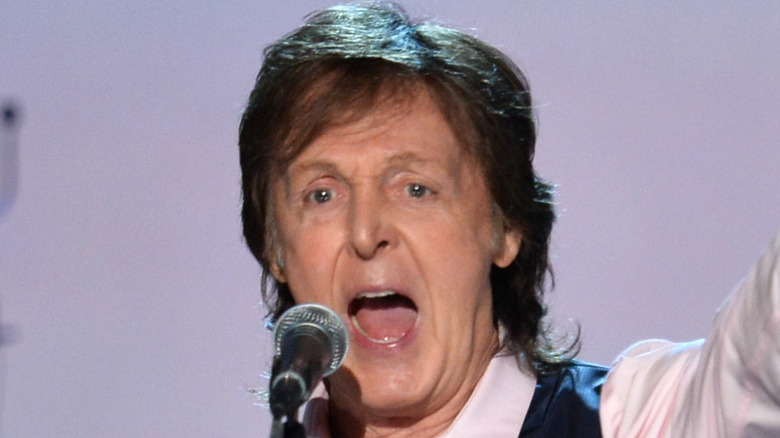 Paul McCartney performing on stage