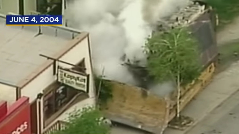 screenshot of news report of killdozer striking building