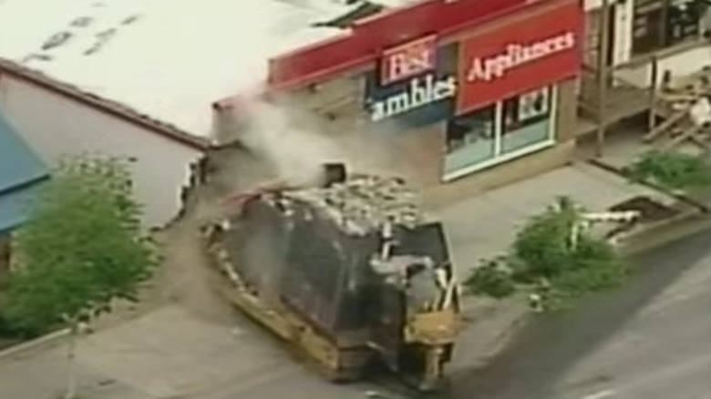 screenshot of news report of killdozer striking building