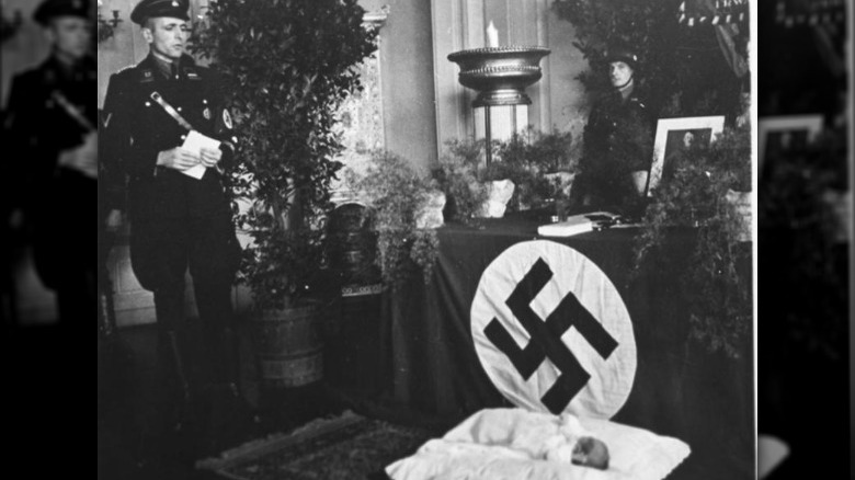 baby in front of a nazi altar