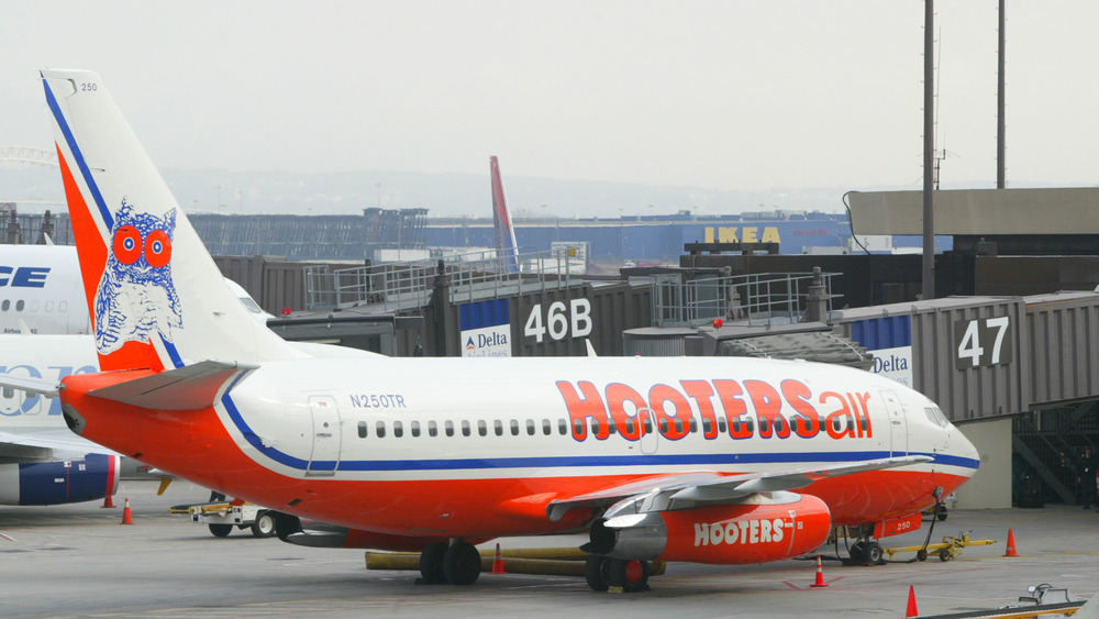 A Hooters plane arrives at Gate 47 