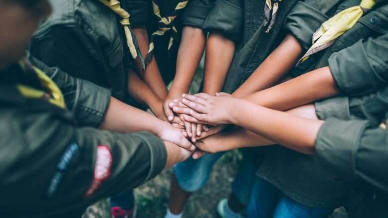 Boy Scouts stacking hands together