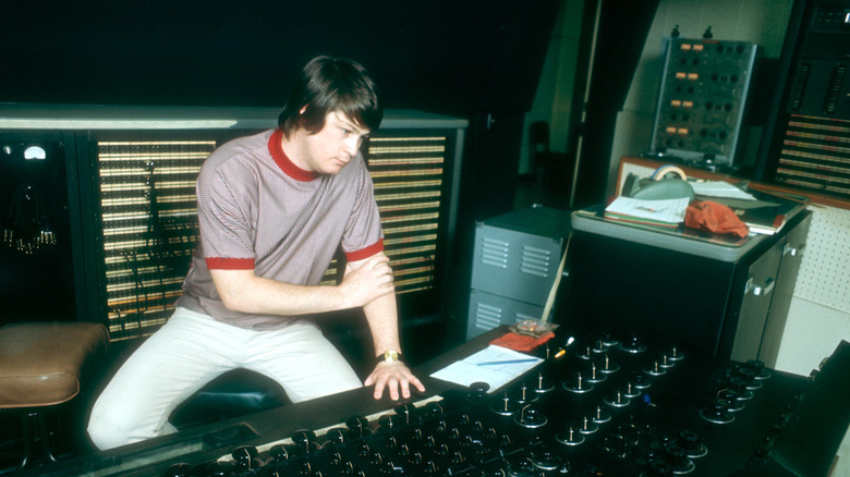 Brian Wilson sat in a studio at a mixing console