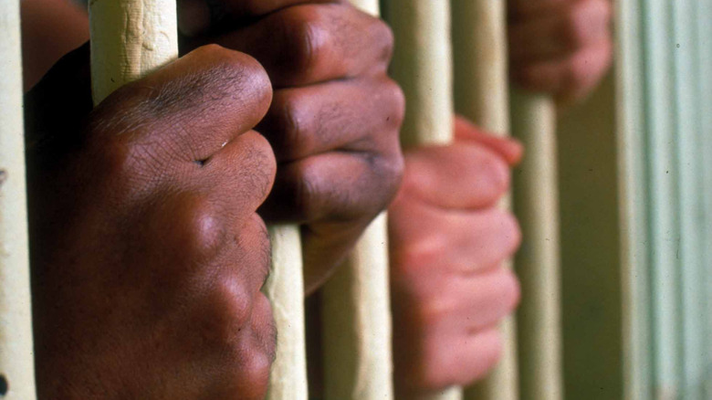 Hands gripping bars of prison cells at Virginia State Penitentiary