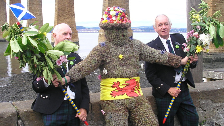 burry man two attendants leaning rocks