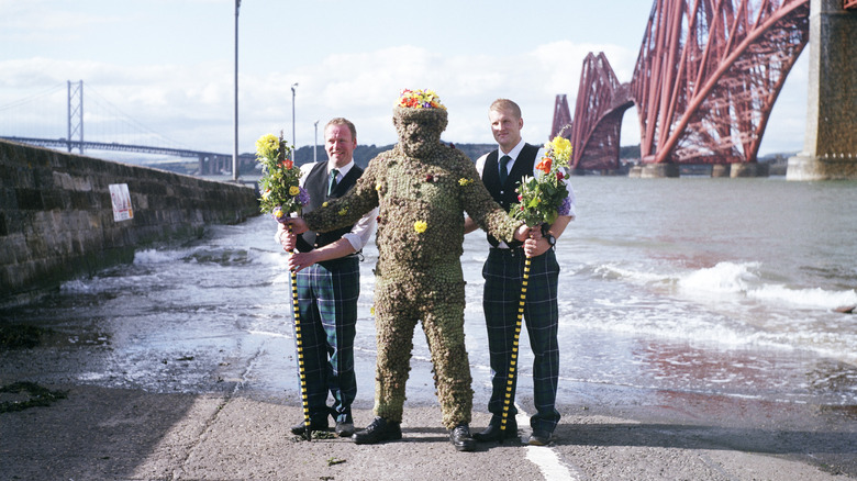 burry man attendants posing camera