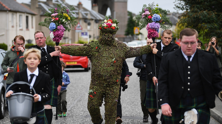 burry man procession people walking
