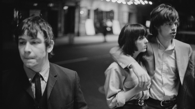 Eric Burdon, Mick Jagger, and a woman in the street.