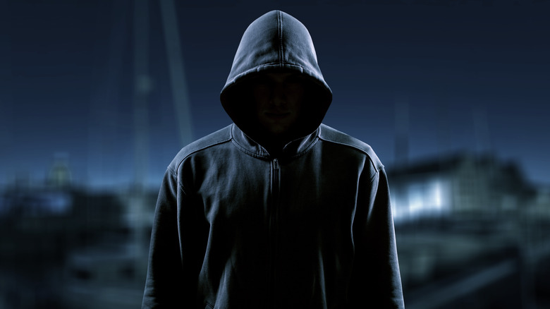 Man in hoodie at night