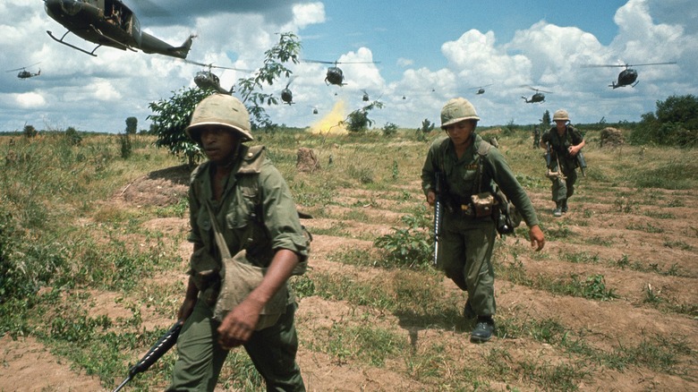 Soldiers walking through field