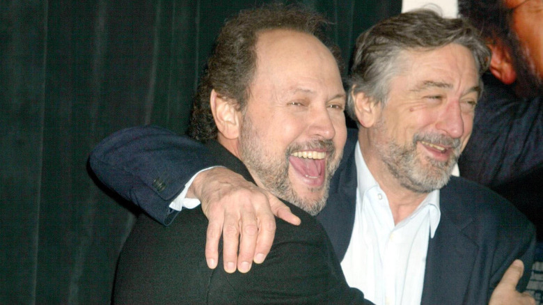 Robert De Niro hugging Billy Crystal smiling