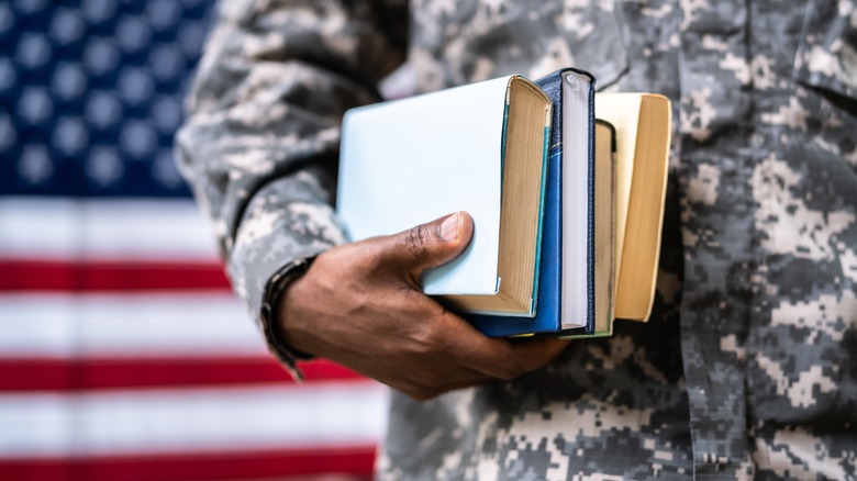 A soldier carrying books