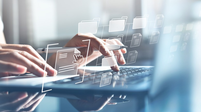 IT consultant working with data on laptop computer 