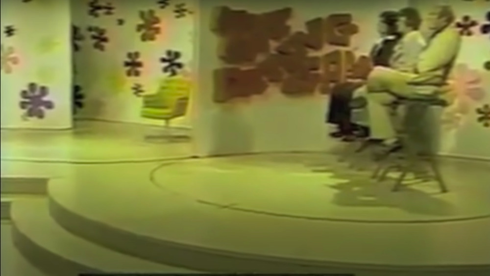 stage of The Dating Game with three male contestants