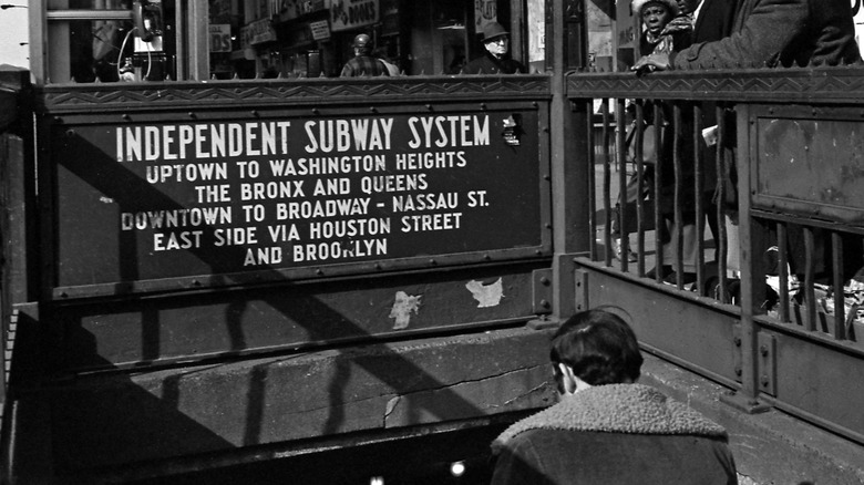 Man descending stairs into the New York City subway
