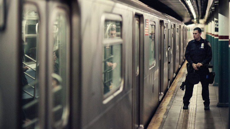 Police officer outside a subway car at Astor Place Station