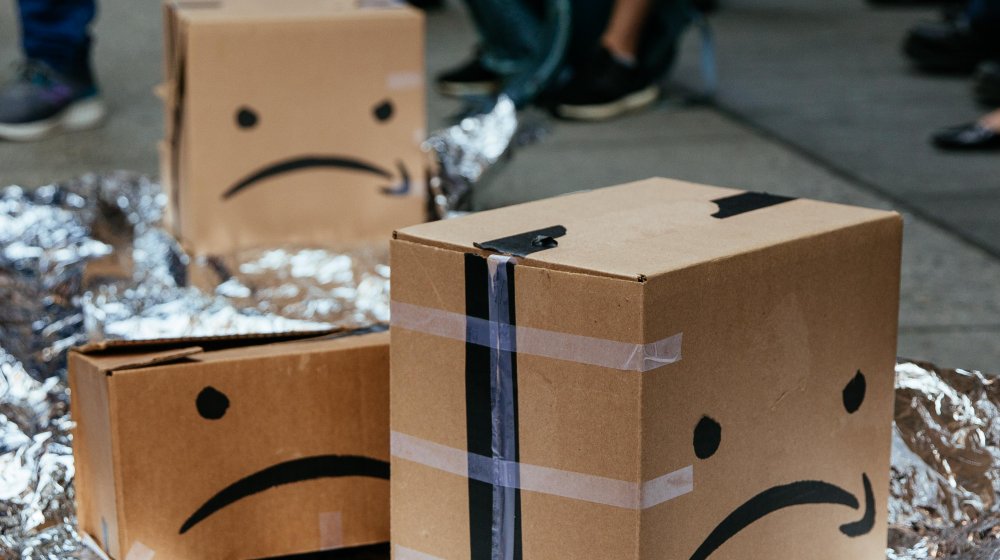 Sad faces drawn on Amazon parcels by protestors