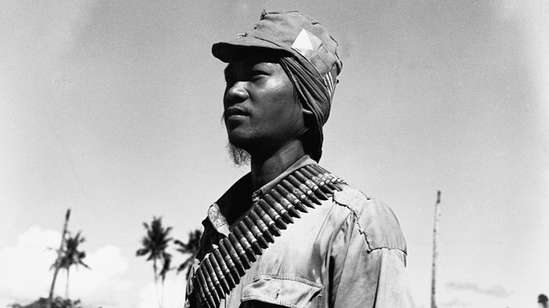 Filipino guerilla in combat gear with ammunition