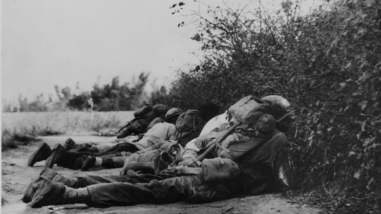 U.S. troops and Filipino guerillas taking cover