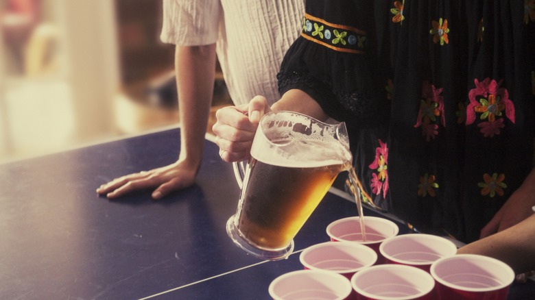 Woman pouring beer into cups