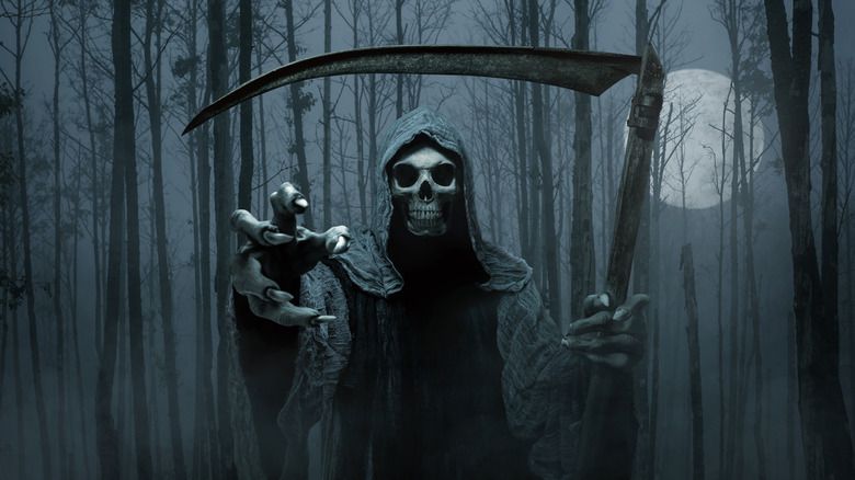 grim reaper reaching for the camera nighttime forest