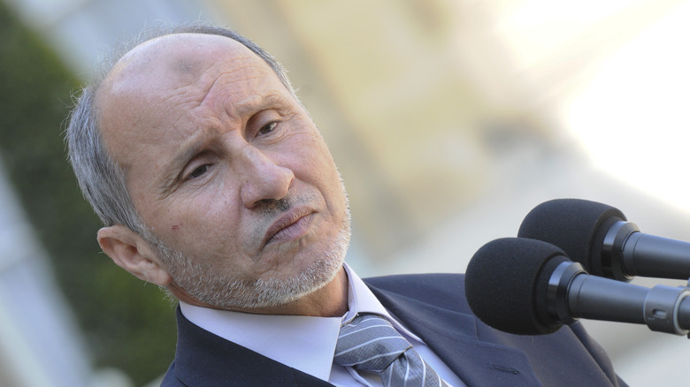 Mustafa Abdul-Jalil in shirt and tie speaking