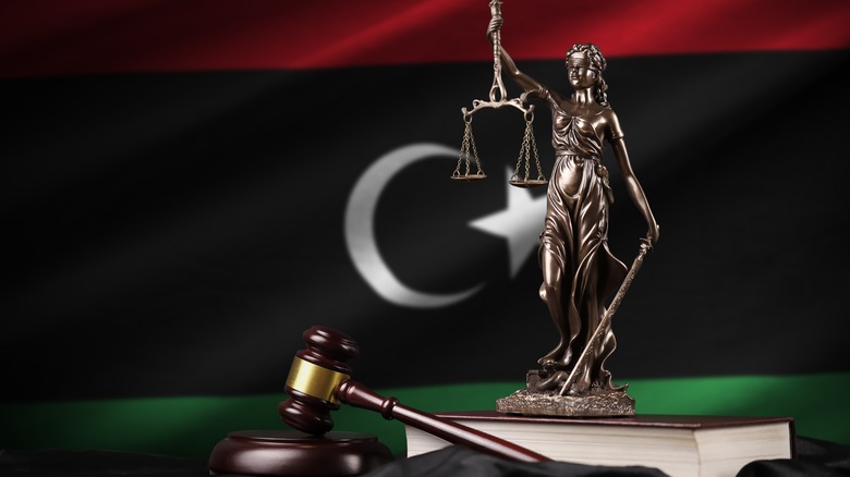 Libyan flag behind lady justice and gavel
