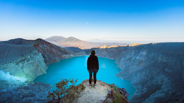 Person standing on cliff at Kawah Ijen