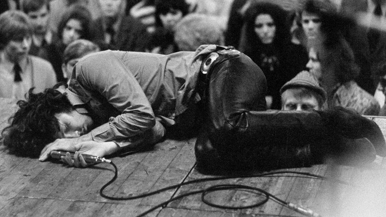 Jim Morrison laying on stage