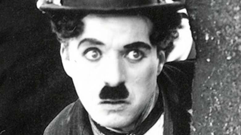 Tom Wilson as a policeman and Charlie Chaplin as The Tramp in 1921's The Kid